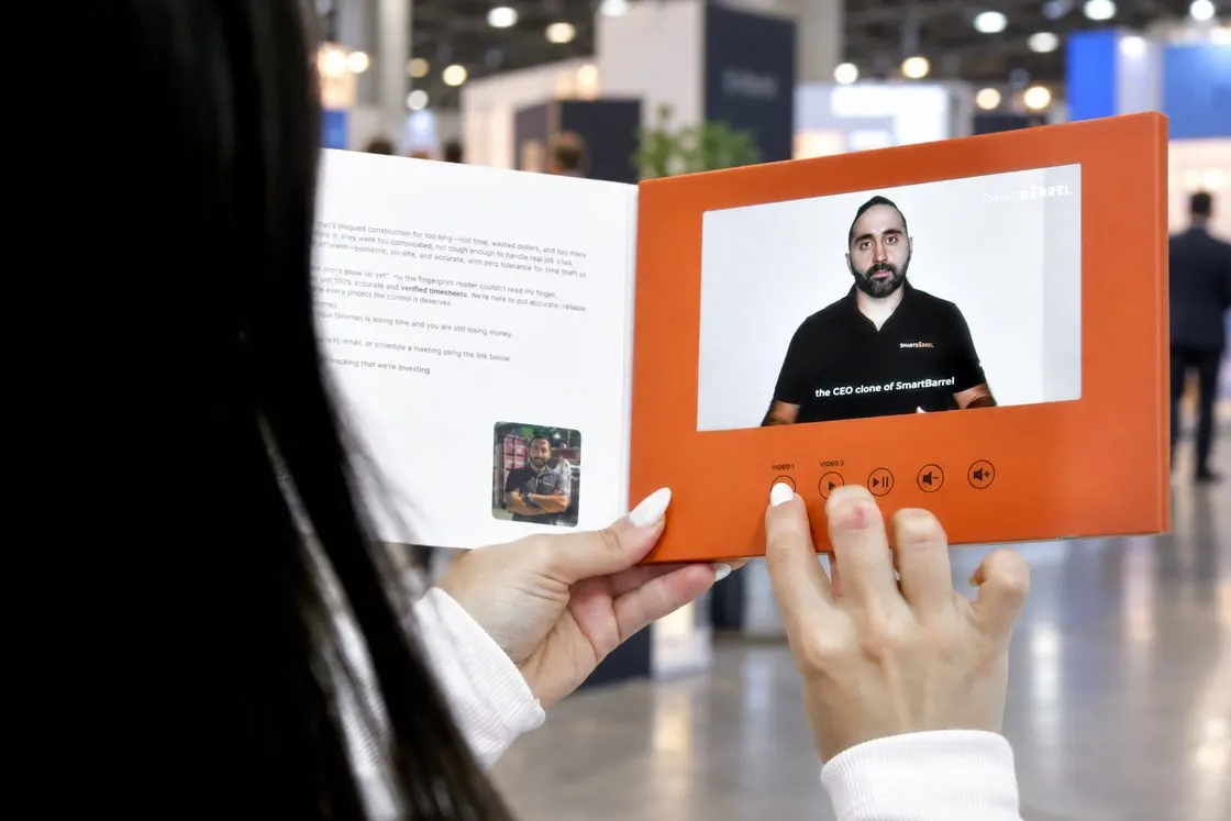A Herald opened at a trade show, a speaker on screen
